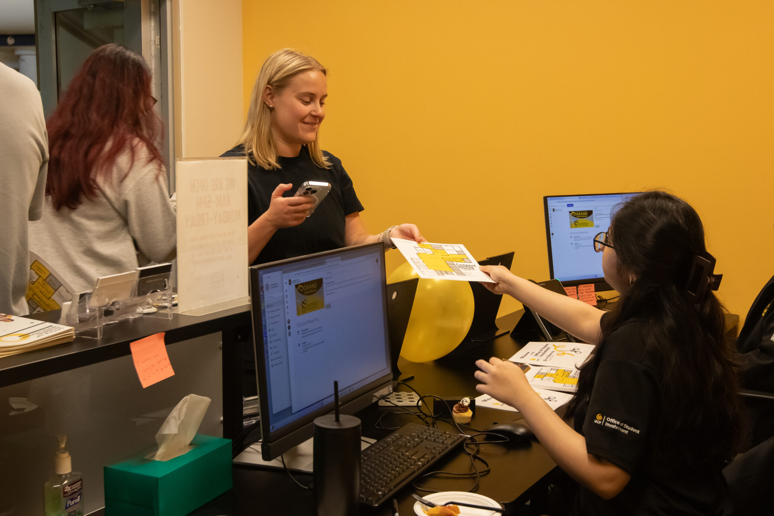 Students checking for assistance at the front desk
