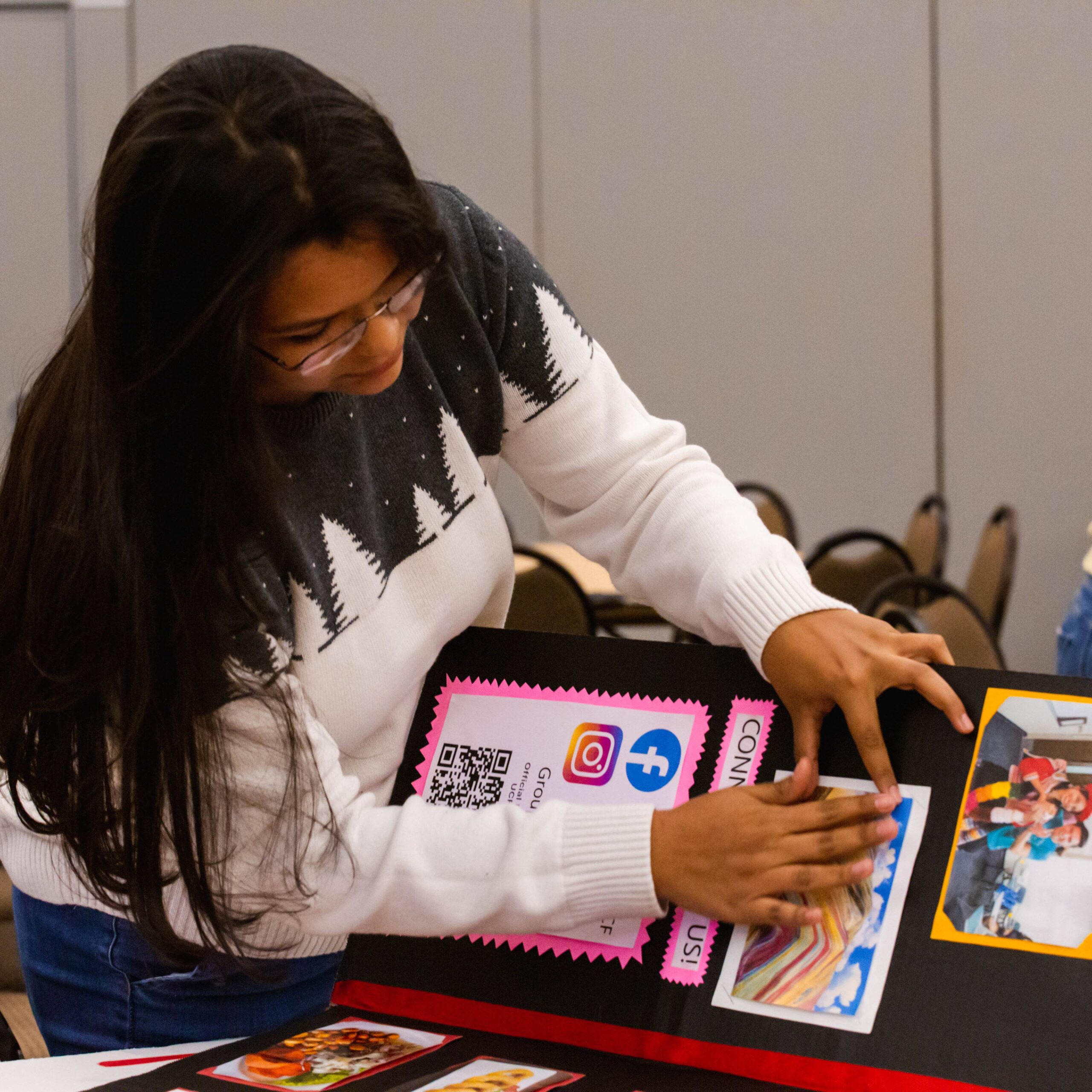 Student Setting Up Posterboard at Event.