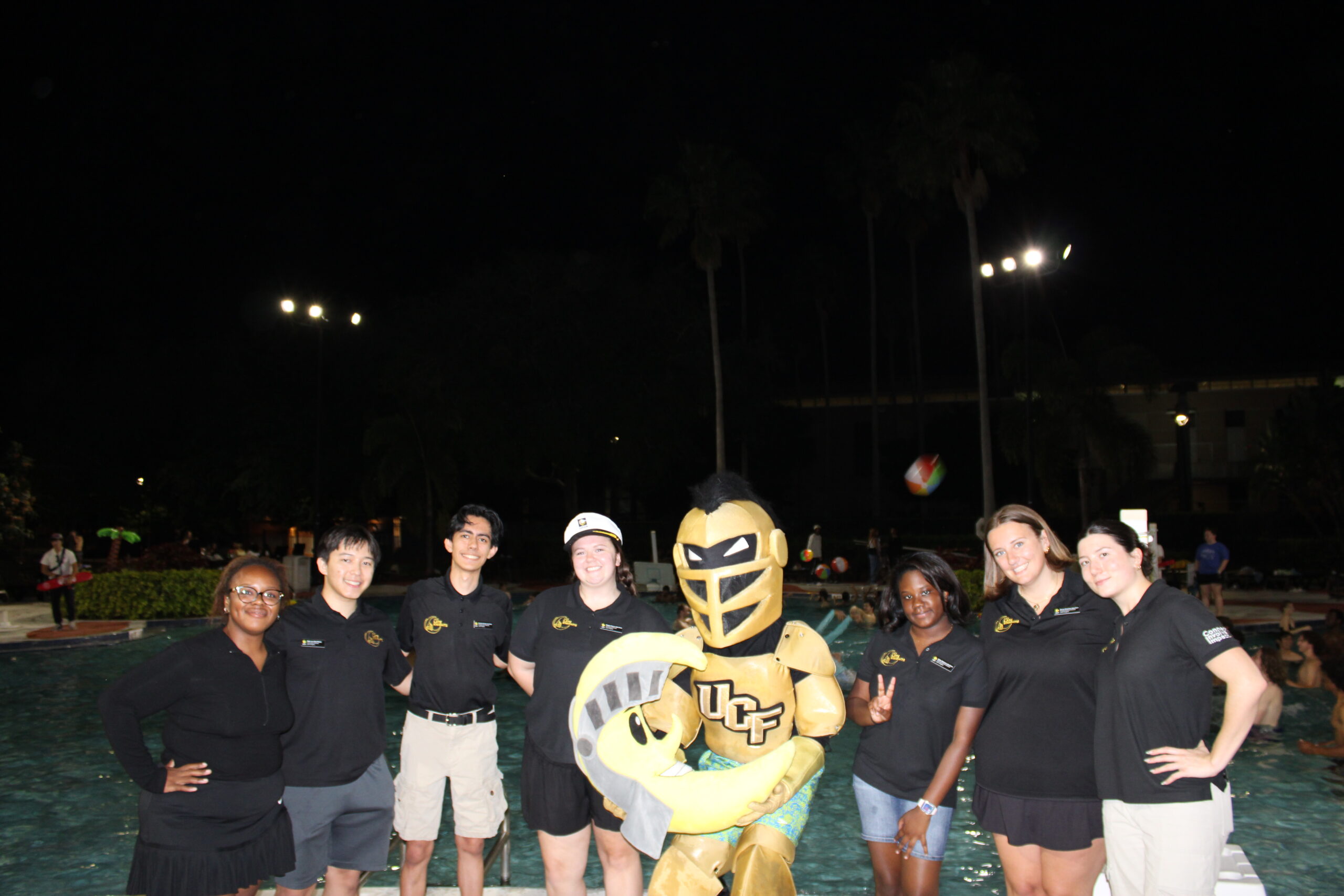 Students standing together with Knightro Mascot at event